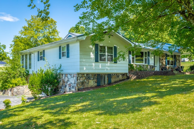 view of side of home featuring a lawn