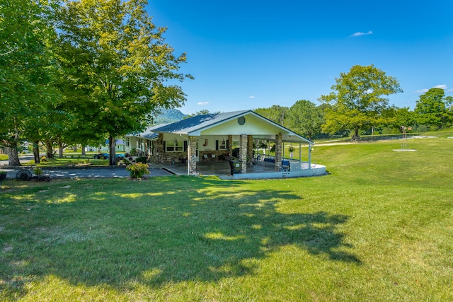 view of home's community featuring a yard and a patio area