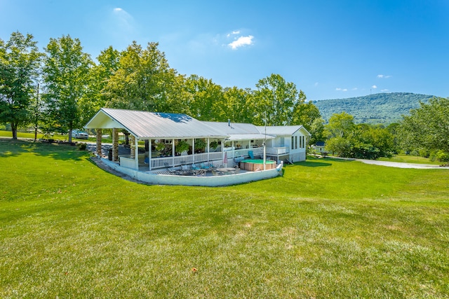 view of home's community featuring a mountain view and a yard