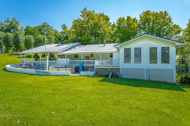 rear view of property featuring a yard