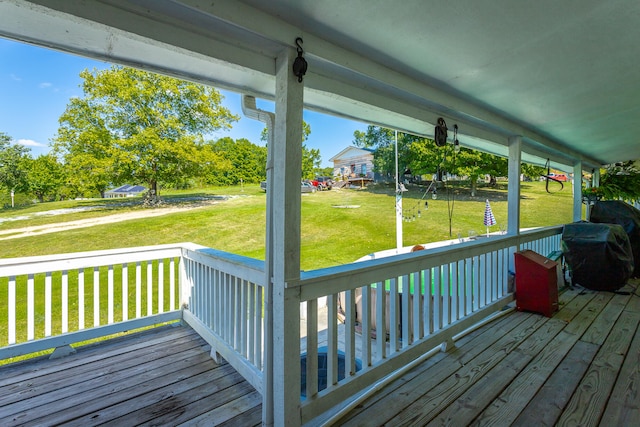 wooden deck with a lawn and grilling area