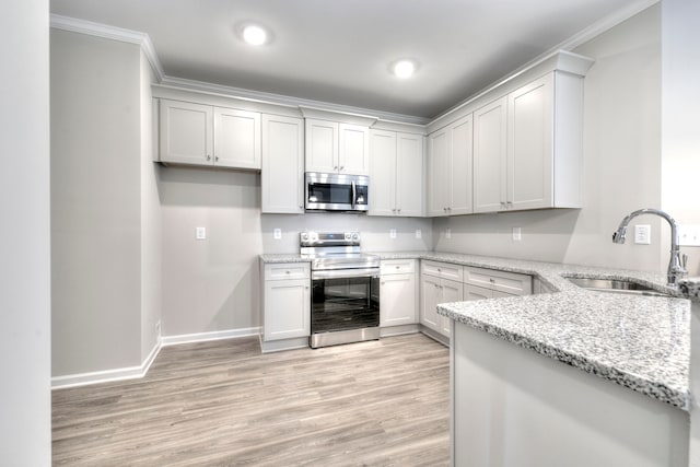 kitchen with light stone countertops, light hardwood / wood-style flooring, appliances with stainless steel finishes, crown molding, and sink