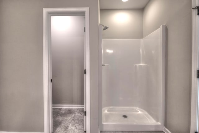 bathroom with a shower and tile patterned floors