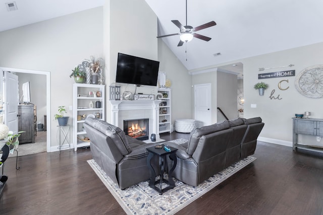 living room with dark wood-type flooring, ceiling fan, and high vaulted ceiling