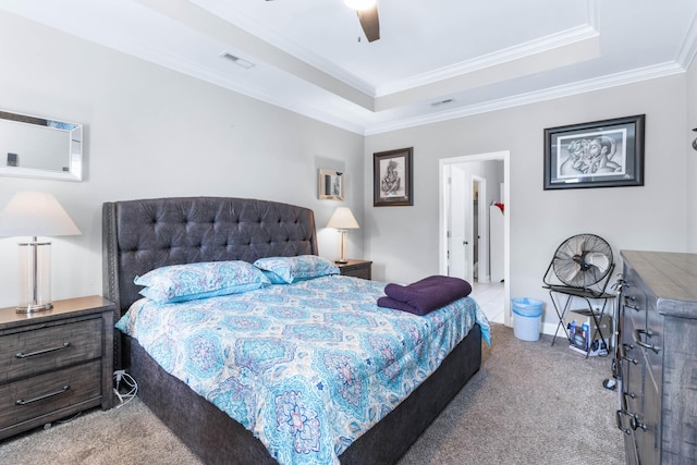 bedroom featuring ceiling fan, light colored carpet, a raised ceiling, and crown molding