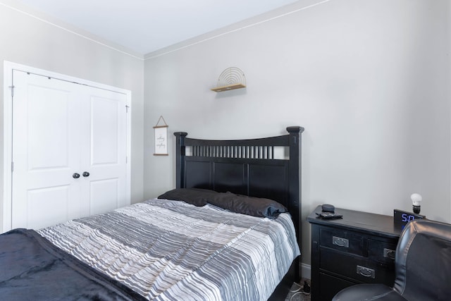 bedroom with a closet and crown molding