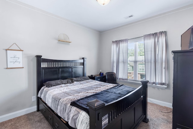 carpeted bedroom featuring crown molding