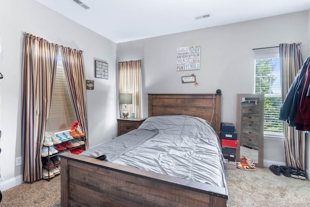 carpeted bedroom featuring multiple windows