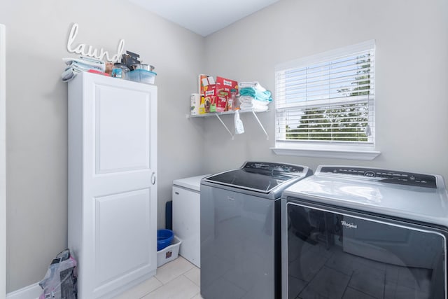 laundry room with separate washer and dryer and light tile patterned floors