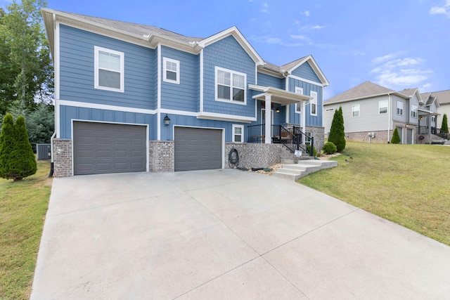 view of front of home featuring central air condition unit, a garage, and a front lawn