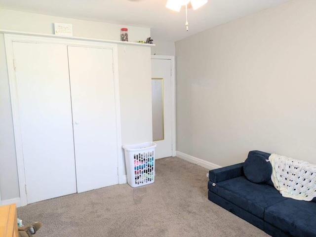 sitting room with ceiling fan and carpet floors