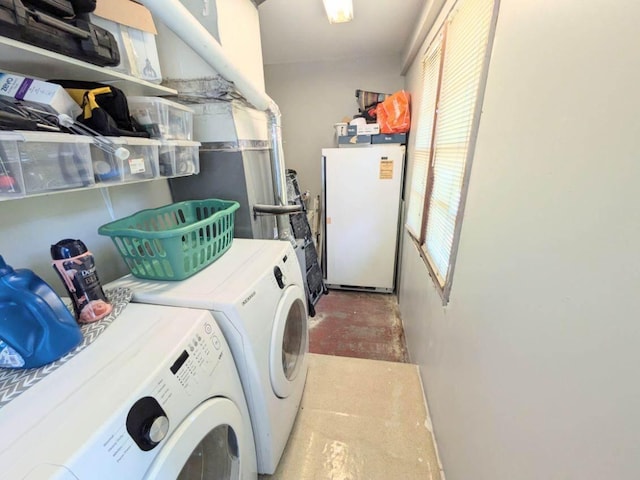 clothes washing area with washing machine and dryer and laundry area