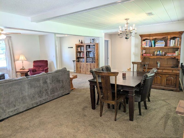 carpeted dining space with a textured ceiling, an inviting chandelier, and beamed ceiling