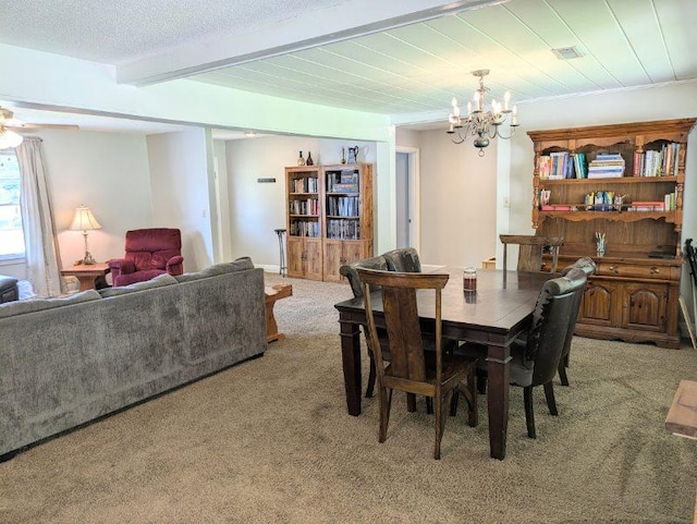 dining area featuring an inviting chandelier, beam ceiling, light colored carpet, and a textured ceiling