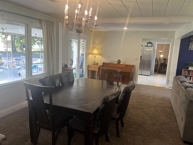 carpeted dining space featuring baseboards, beamed ceiling, a chandelier, and wood ceiling