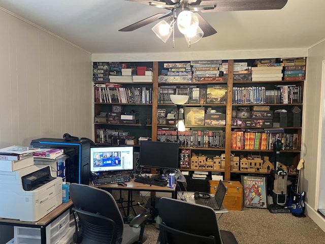 carpeted office with a ceiling fan