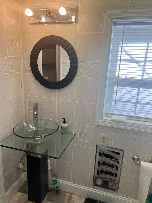 bathroom with tile walls and sink