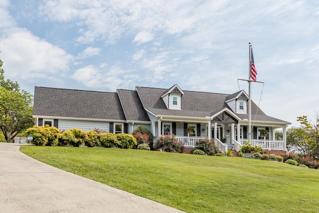 cape cod home with covered porch and a front yard