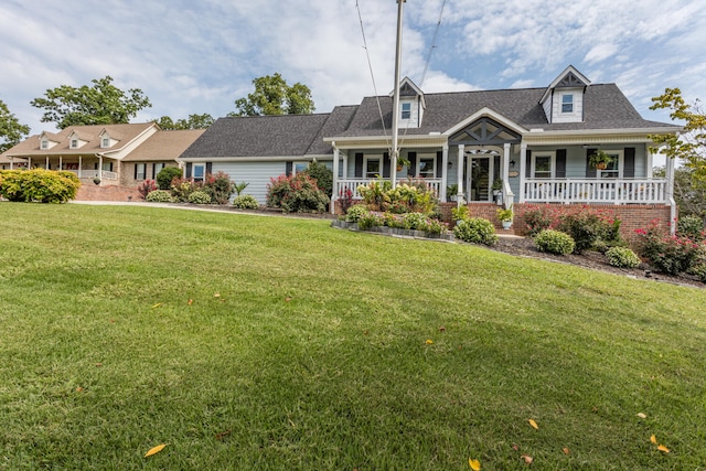 cape cod home with a front lawn and covered porch