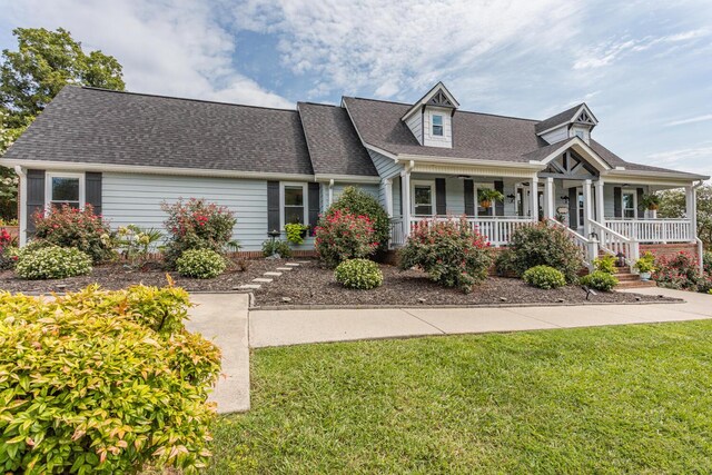 view of front of property featuring a porch and a front lawn