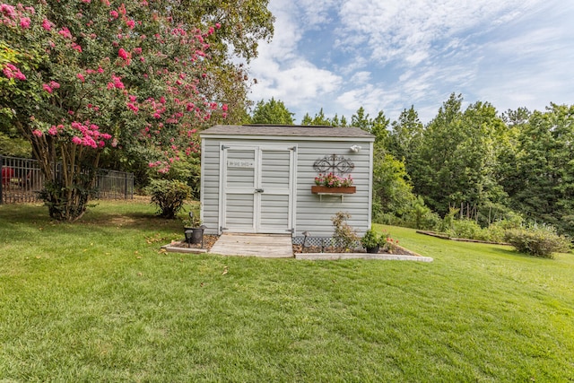 view of outbuilding with a yard