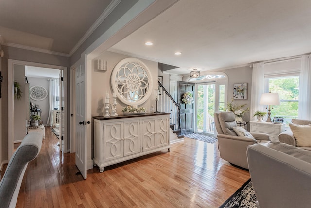 living room featuring light wood-type flooring and ornamental molding