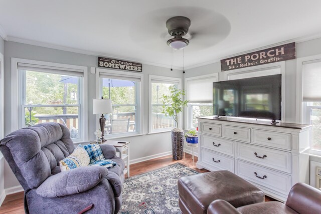 living room with ornamental molding, light hardwood / wood-style flooring, and ceiling fan