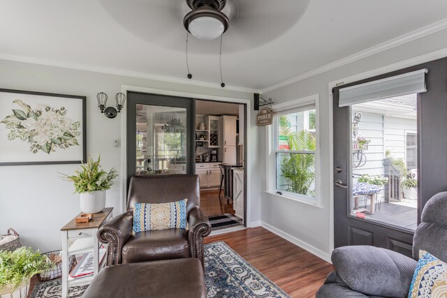 living room featuring ornamental molding, hardwood / wood-style floors, and ceiling fan