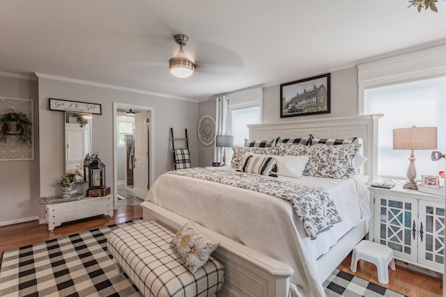 bedroom with ornamental molding, multiple windows, and hardwood / wood-style floors