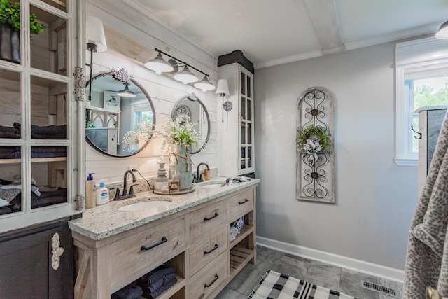 bathroom with crown molding and vanity