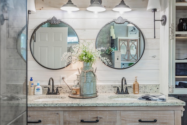 bathroom featuring vanity and wood walls