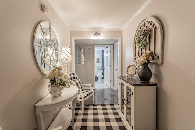 foyer entrance with tile patterned flooring and ornamental molding