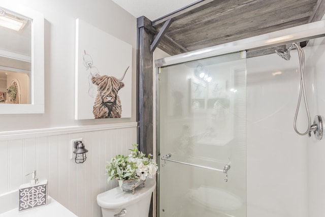 bathroom with toilet and an enclosed shower