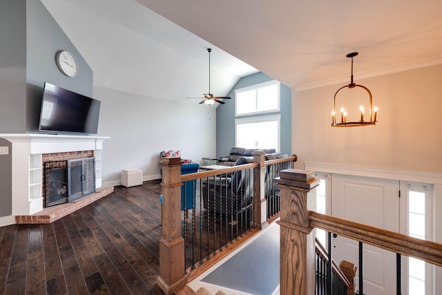 corridor featuring vaulted ceiling, dark hardwood / wood-style flooring, and a chandelier