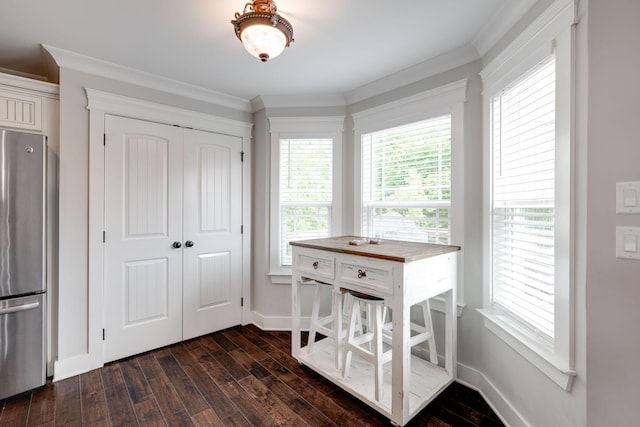 dining space with dark hardwood / wood-style floors and ornamental molding