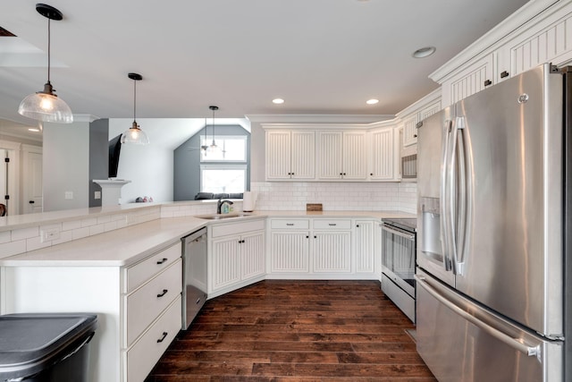 kitchen with backsplash, kitchen peninsula, appliances with stainless steel finishes, and dark hardwood / wood-style flooring