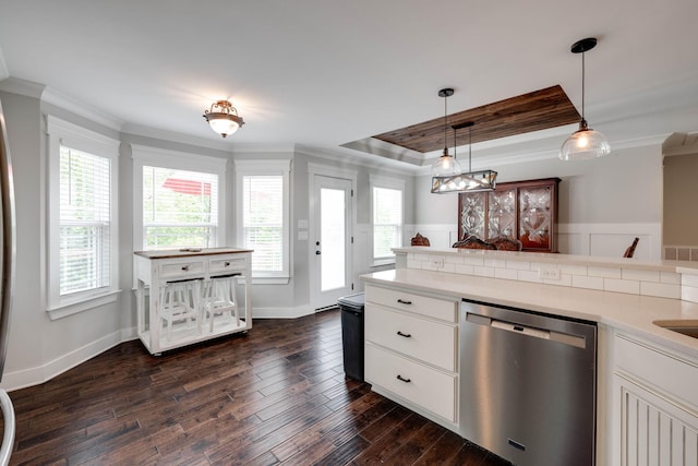 kitchen with pendant lighting, ornamental molding, white cabinetry, dishwasher, and dark hardwood / wood-style flooring