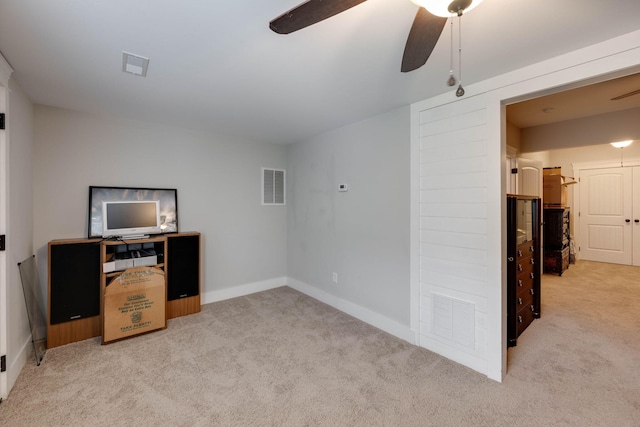 carpeted home office with ceiling fan