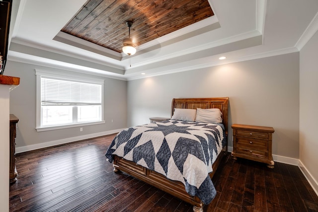 bedroom with crown molding, dark wood-type flooring, ceiling fan, and a tray ceiling