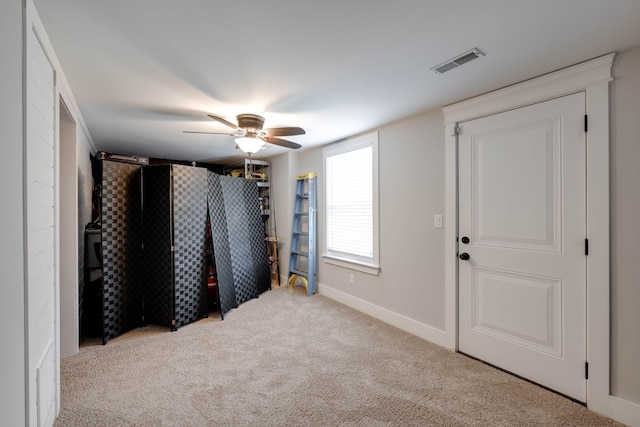 interior space with ceiling fan