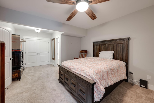 carpeted bedroom featuring a closet and ceiling fan