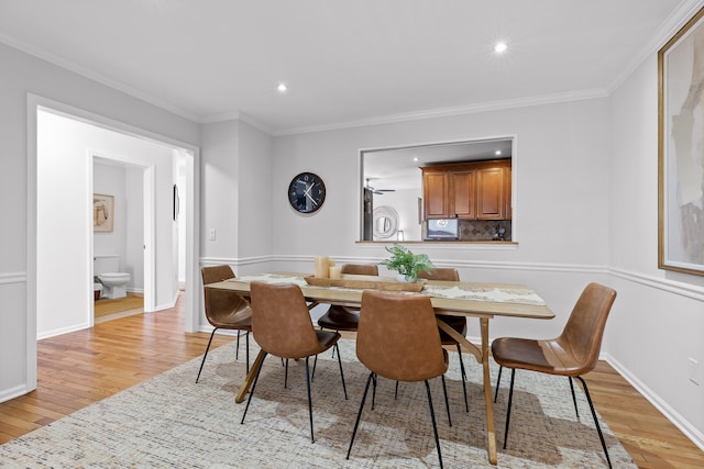 dining area featuring light hardwood / wood-style floors and ornamental molding