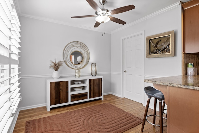 sitting room with crown molding, light hardwood / wood-style flooring, and ceiling fan