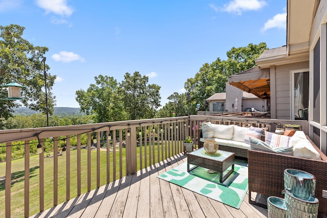 deck featuring a lawn and an outdoor hangout area