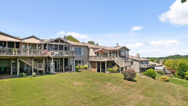 rear view of property featuring a yard and a deck