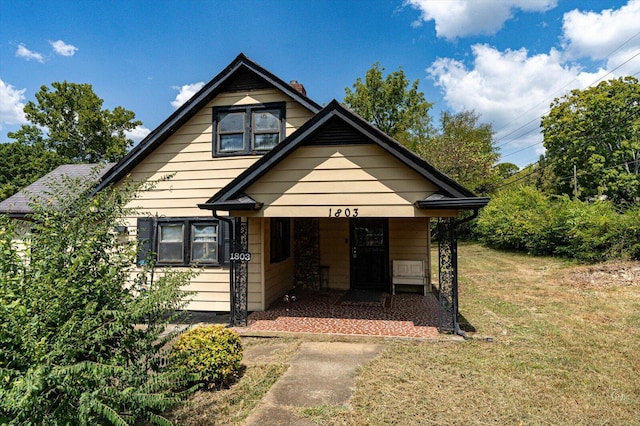 bungalow-style home with a front lawn