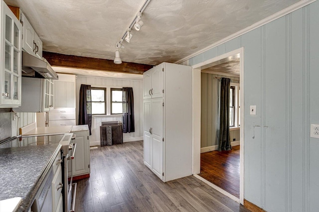 kitchen featuring white stove, crown molding, hardwood / wood-style flooring, white cabinets, and track lighting