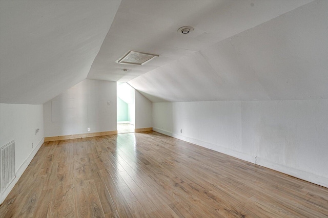 bonus room featuring vaulted ceiling and light hardwood / wood-style flooring