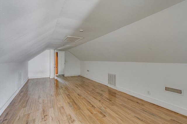 bonus room featuring vaulted ceiling and light hardwood / wood-style floors