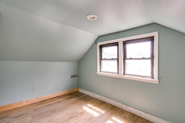 bonus room featuring vaulted ceiling and light hardwood / wood-style flooring